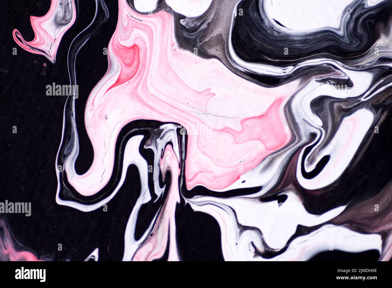 Marbled acrylic colored pattern in the colors red, black, white and pink. Stock Photo