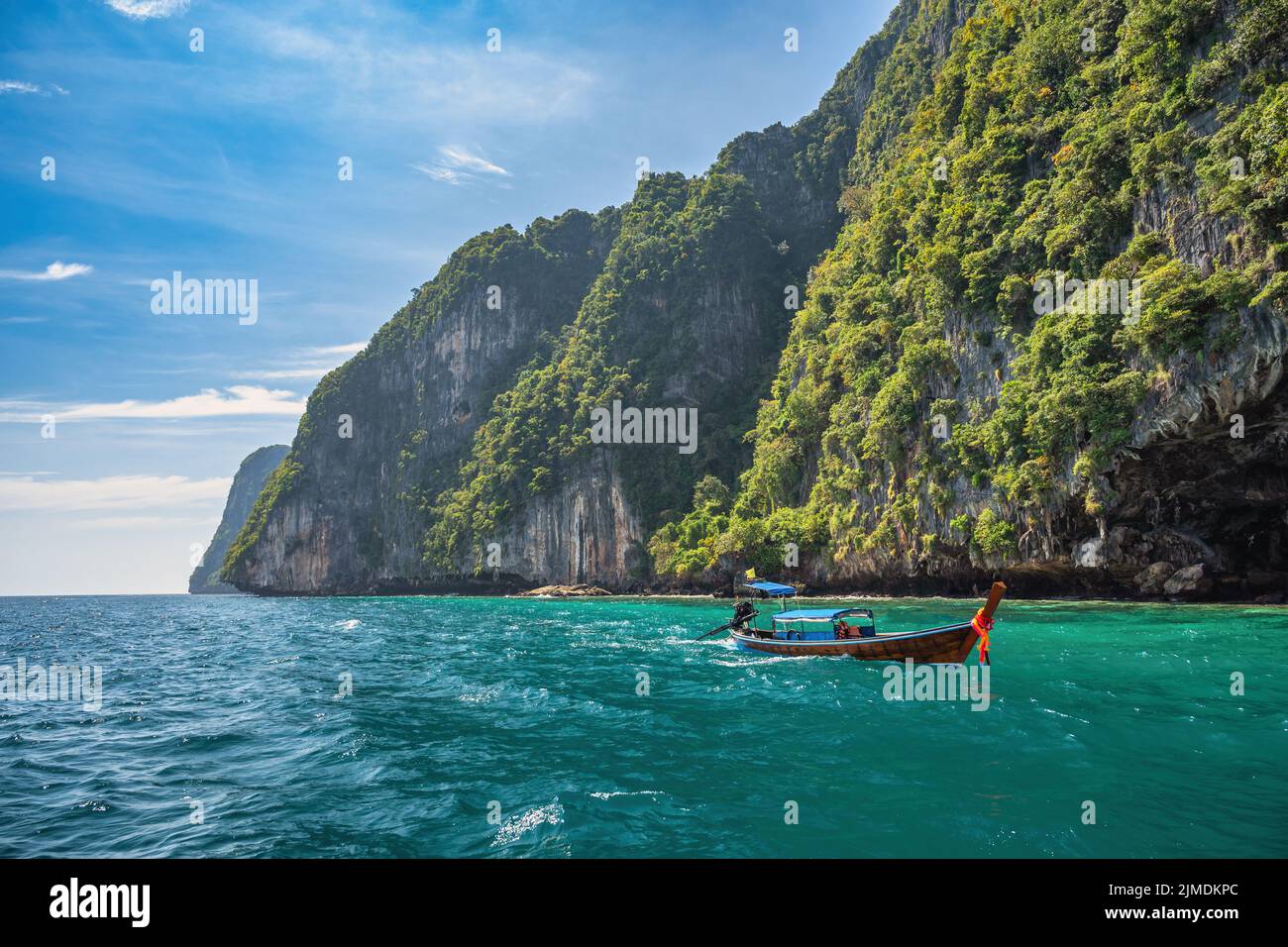 Tropical islands view with long tail boat and ocean blue sea water at Phi Phi Islands, Krabi Thailan Stock Photo