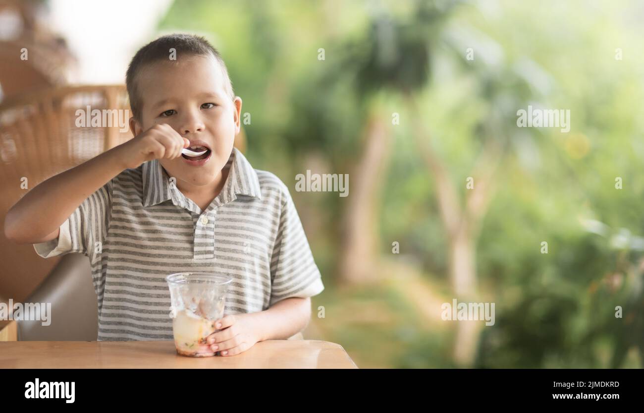 Boy eating icecream in outdoor cafe Stock Photo Alamy
