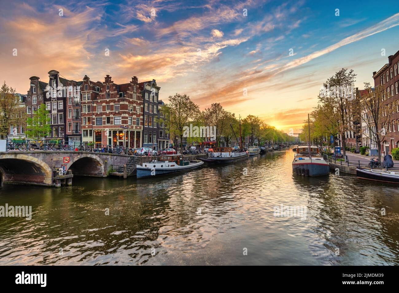 Amsterdam Netherlands, sunset city skyline of Dutch house at canal waterfront Stock Photo
