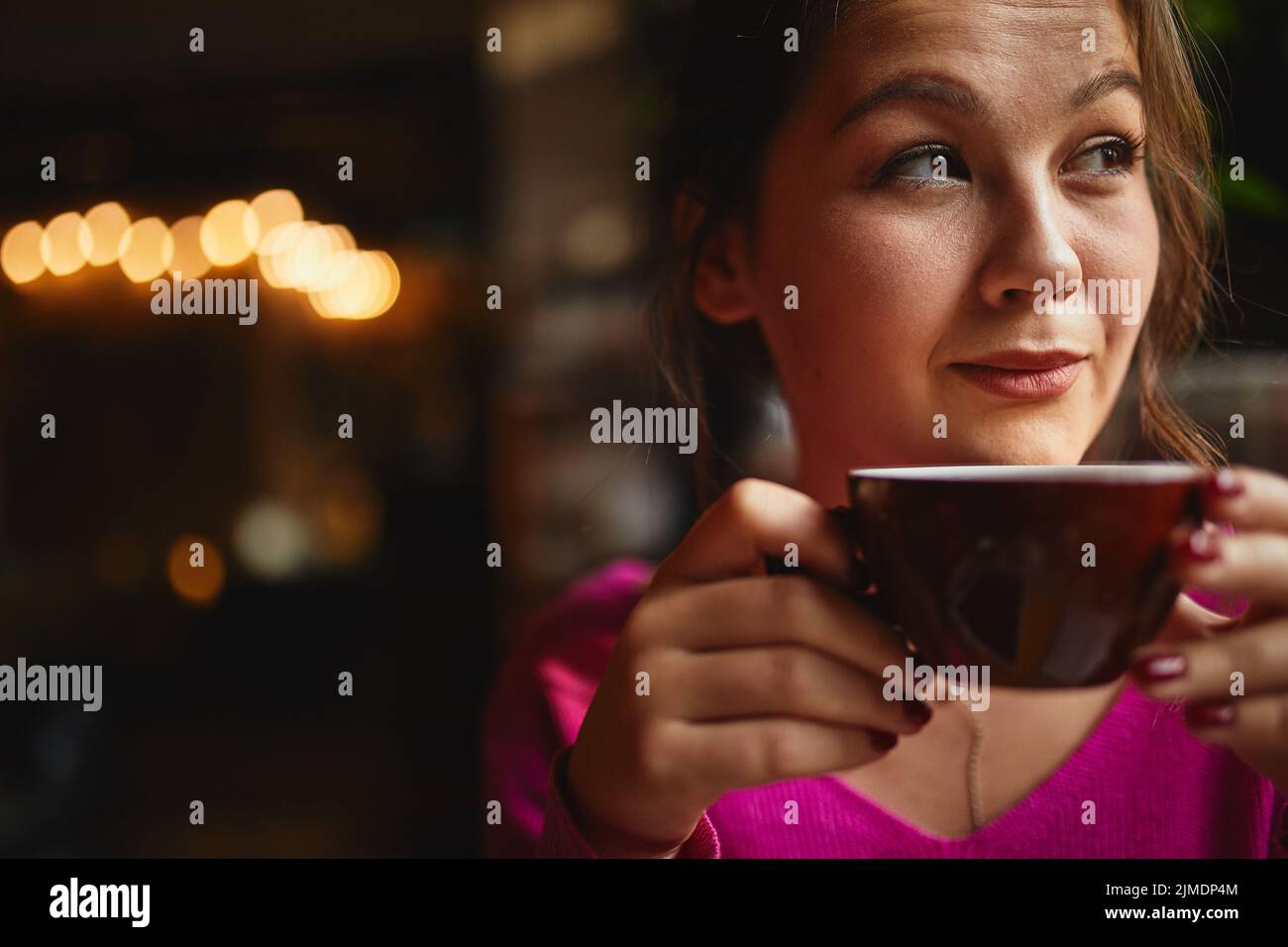 Pretty holding red cup in hands in cafe Stock Photo Alamy
