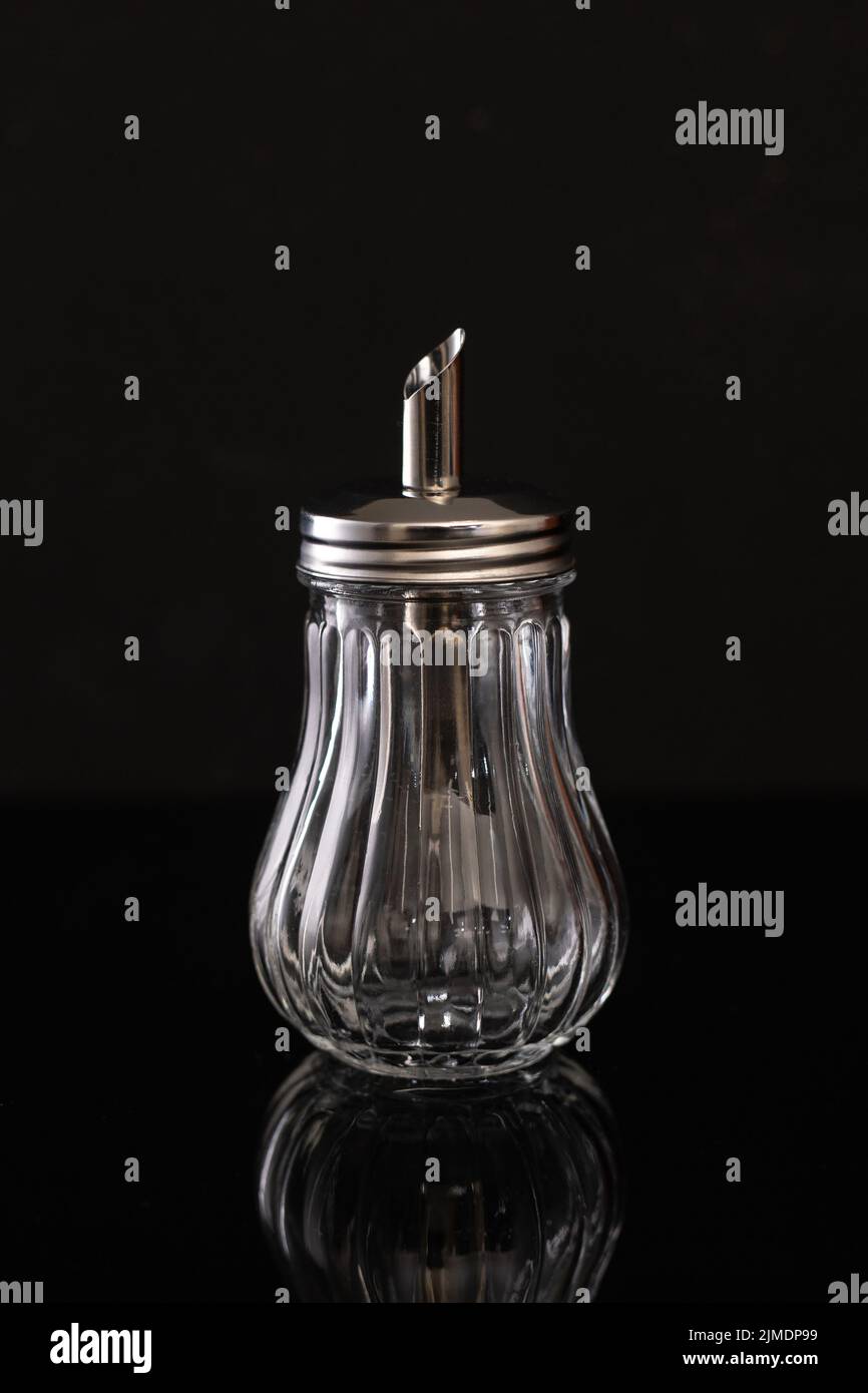Glass sugar bowl on black background whith reflection Stock Photo