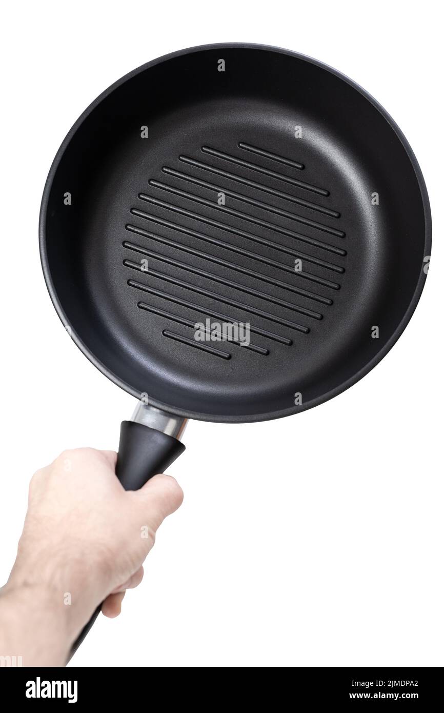 Man holding a cast iron frying pan of grill pan type isolated on white