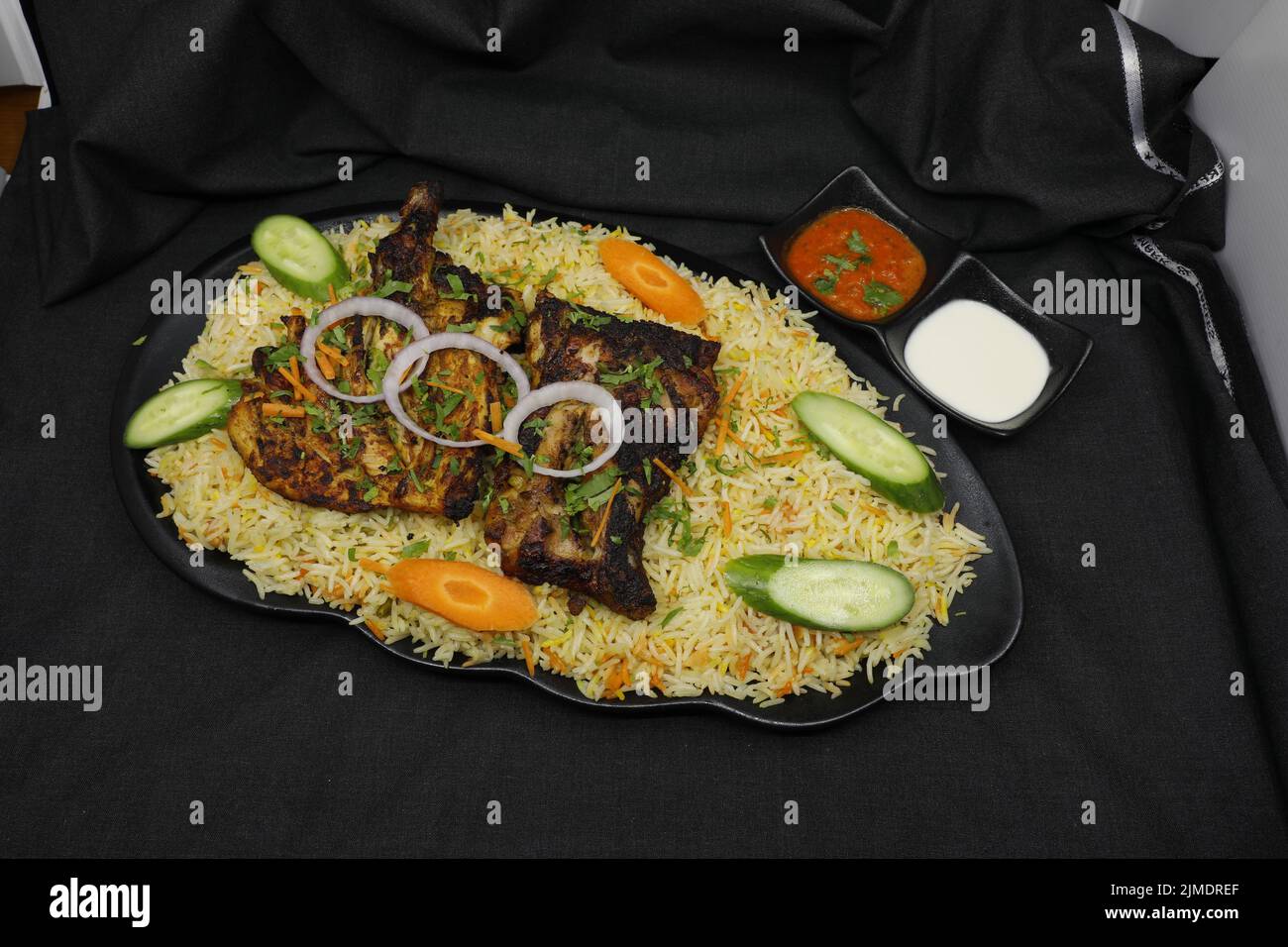 Chicken Charcoal with Arabic Mandi rice on black plate Stock Photo Alamy
