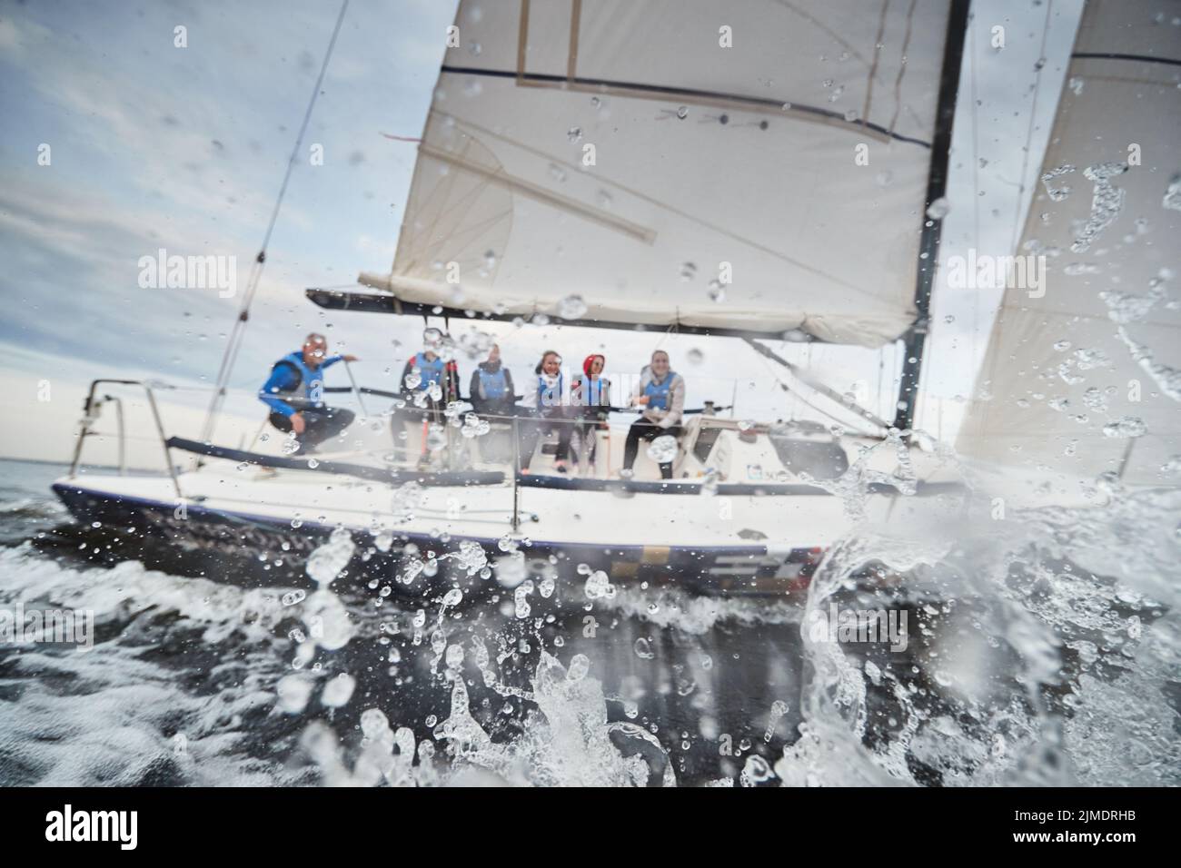 Russia, St.Petersburg, 05 September 2020: Participants of a sailing regatta on the sailboat, pull ropes, water splashes in the f Stock Photo