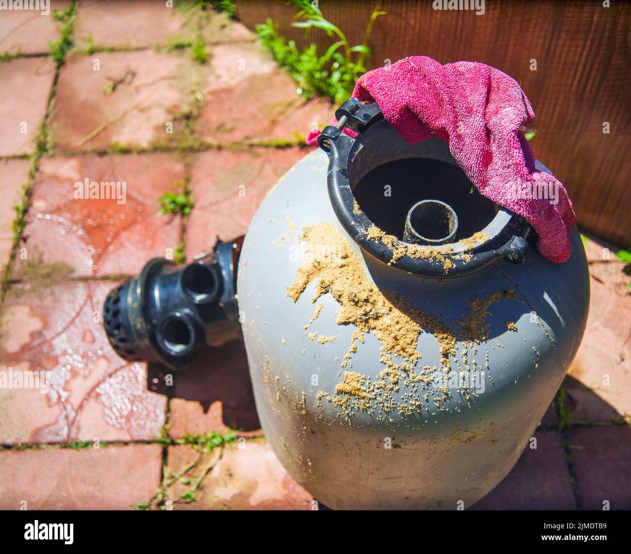 a disassembled or clogged sand filter for outdoor swimming pool, sunny
