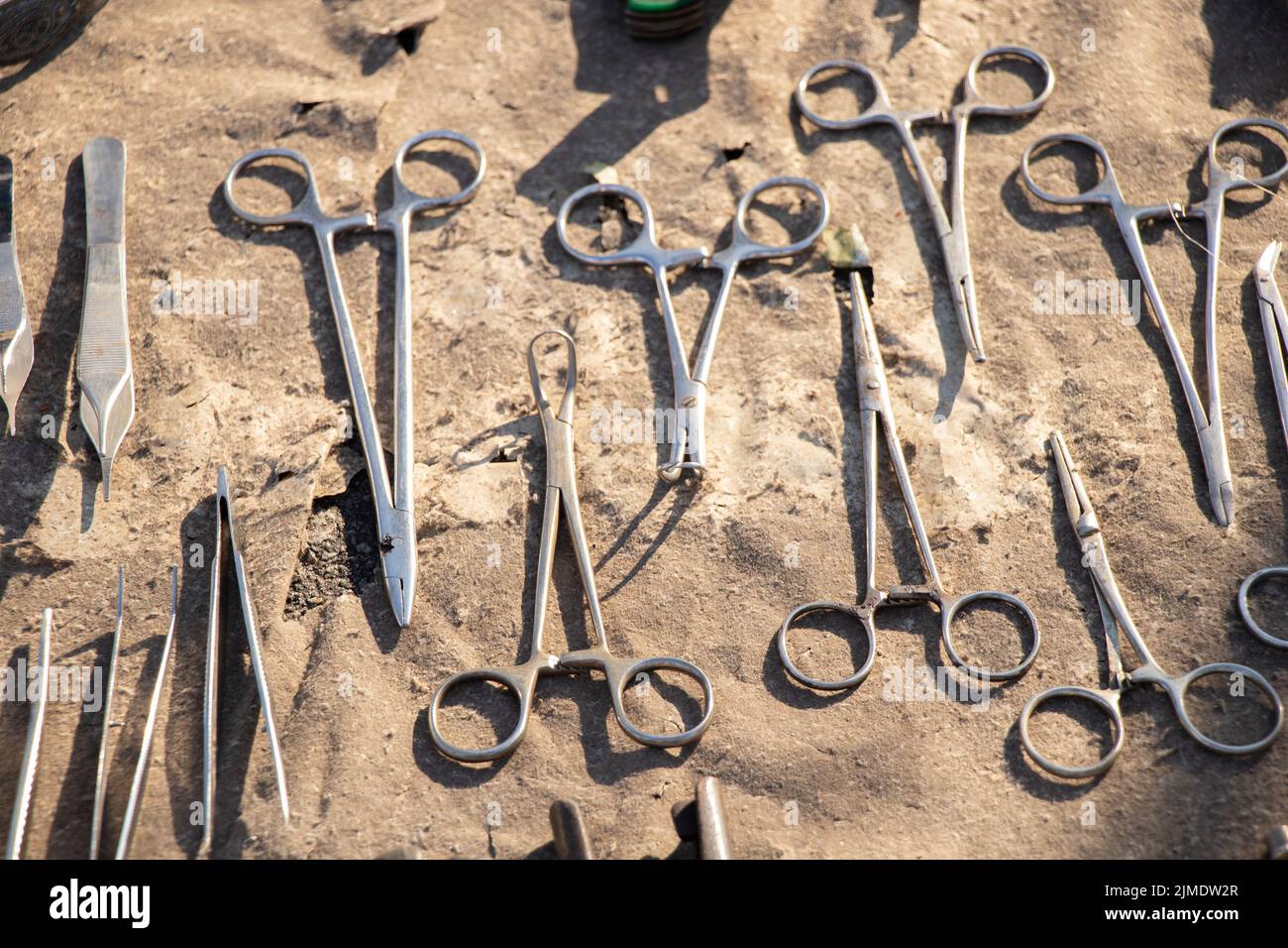 medical clamps and tweezers on an isolated background close-up old and dirty Stock Photo
