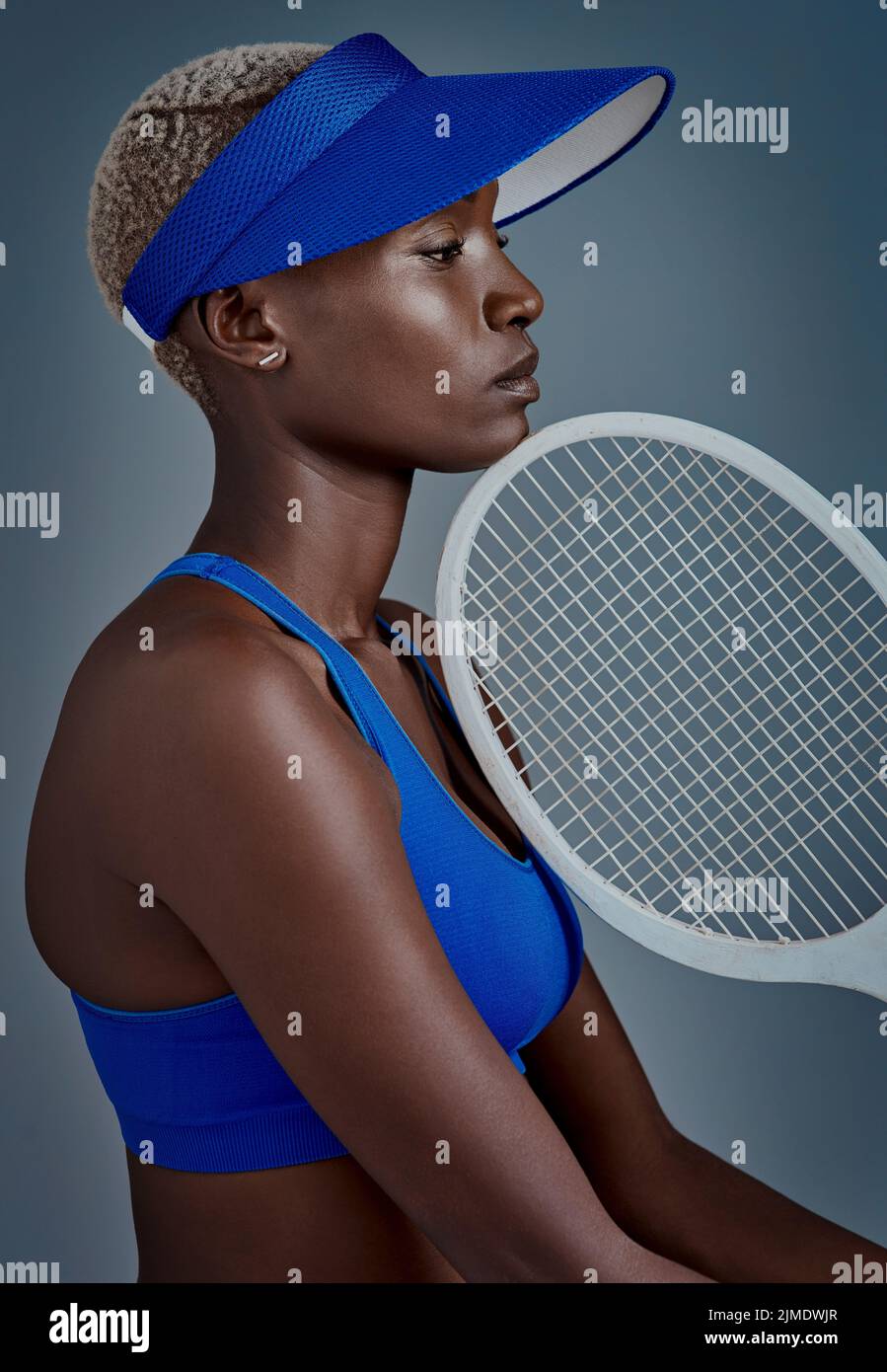 Photo Poses With Racket I live for tennis. Studio shot of a sporty young woman posing with a ...