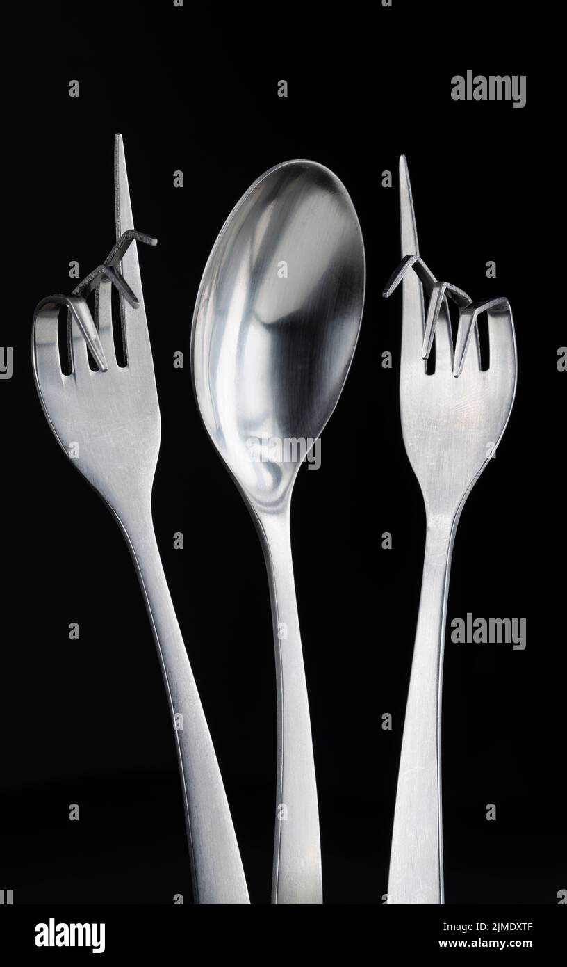Conceptual figure of a spoon and two curved forks Stock Photo Alamy