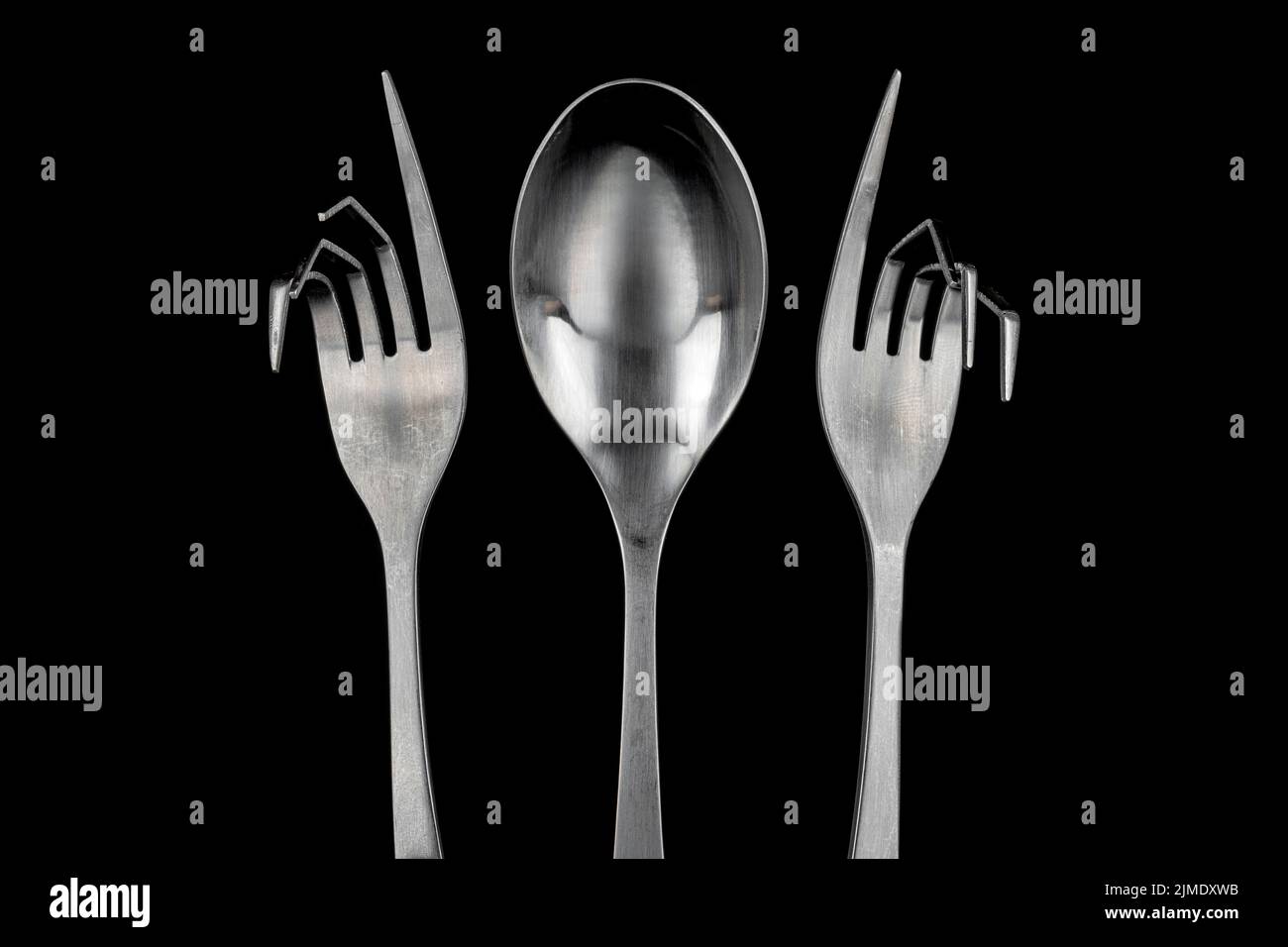 Conceptual figure of a spoon and two curved forks Stock Photo Alamy