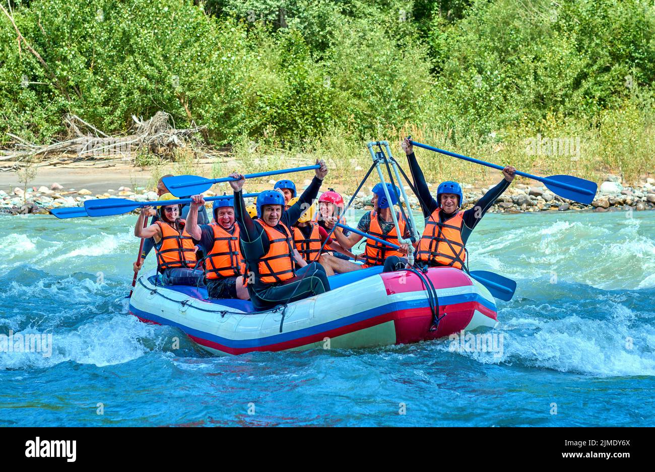 cheerful team is rafting on a mountain river Stock Photo