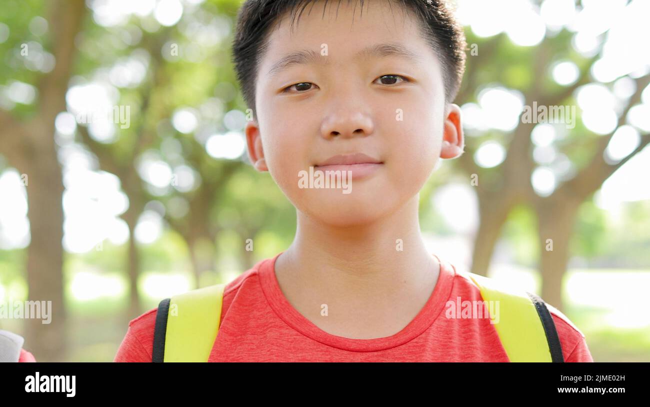 Portrait of happy  Asian boy outside the primary school Stock Photo