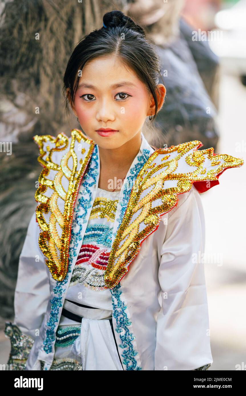 Young adults in traditional ethnic clothing at a festival in Yangon