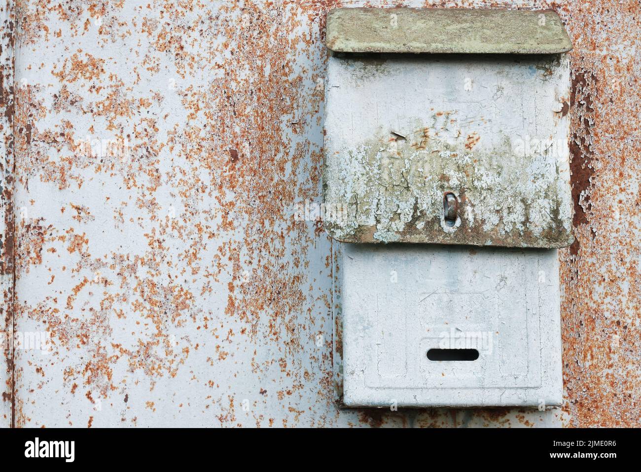 Old mailbox for paper letters. Rusted metal blue wall Stock Photo