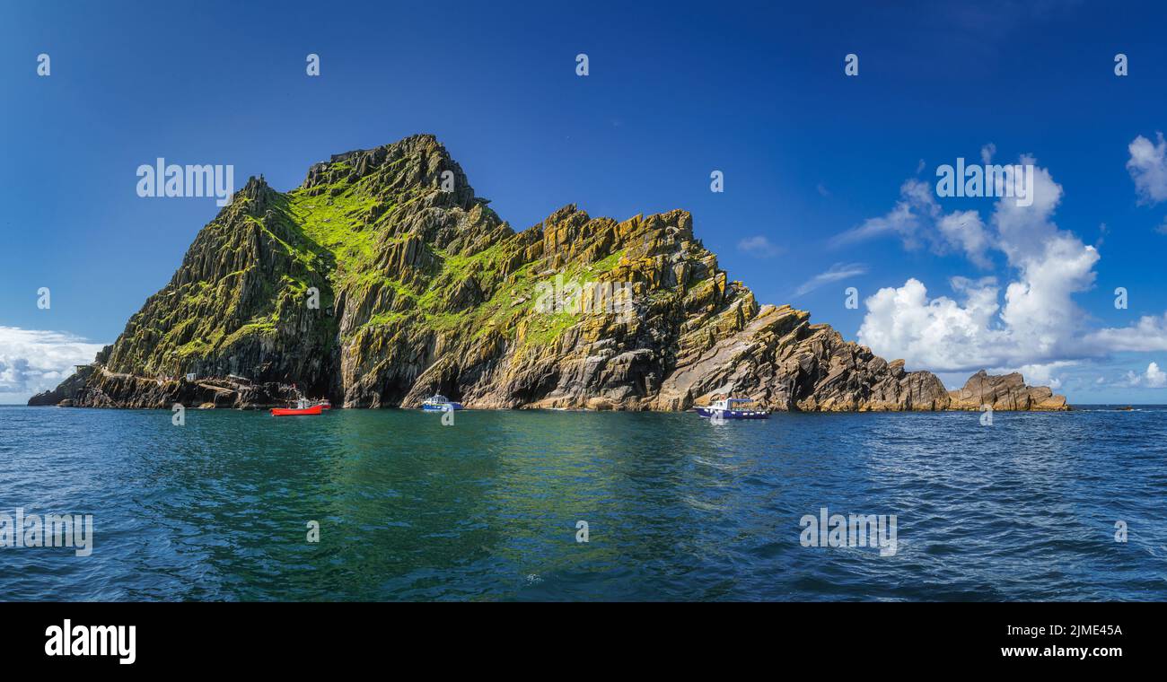 Large panorama with cruise boats docking to Skellig Michael island, where Star Wars were filmed