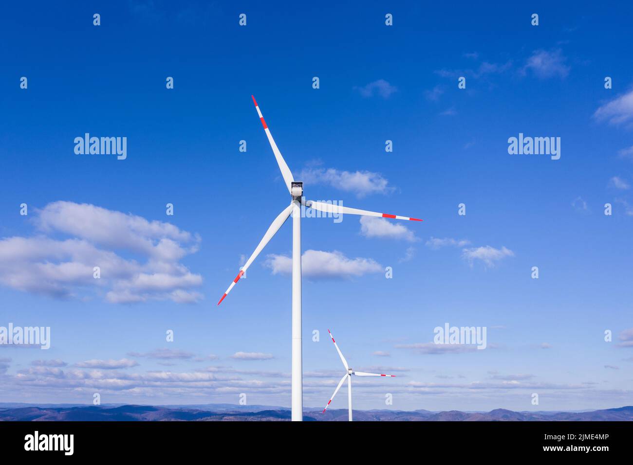 Wind turbines in front of a blue sky Stock Photo - Alamy