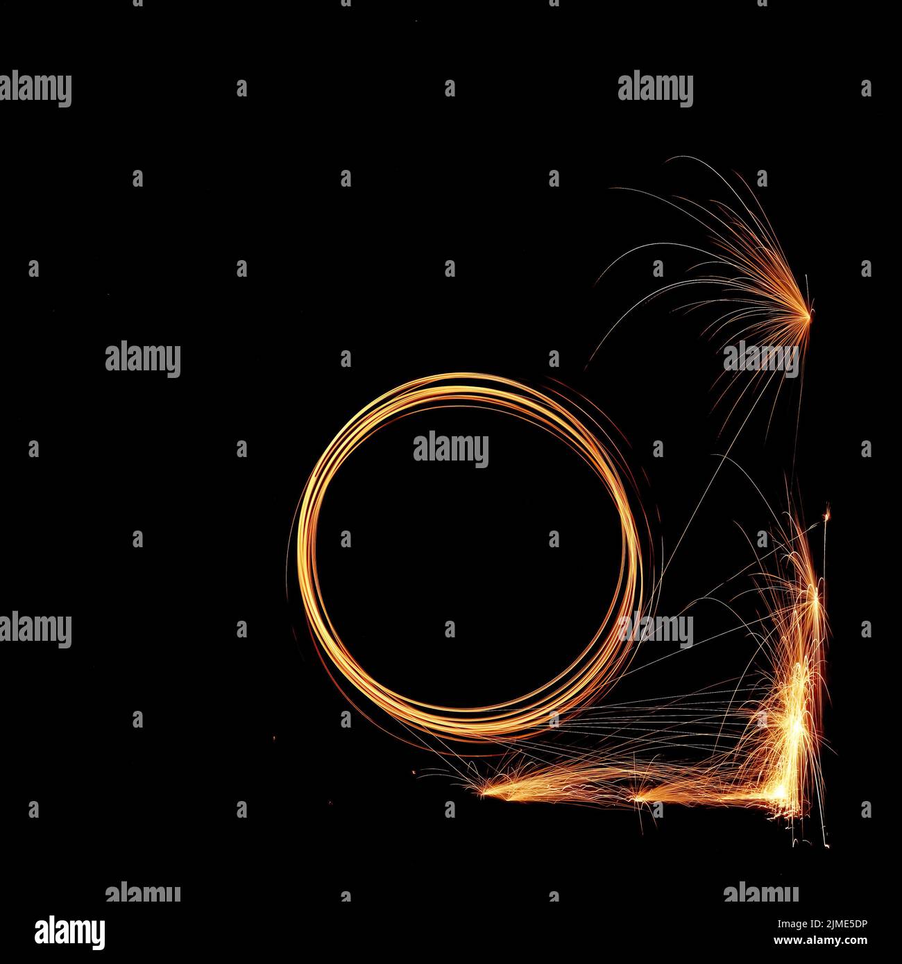 Steel wool spinning in a tunnel, throwing off yellow and orange sparks