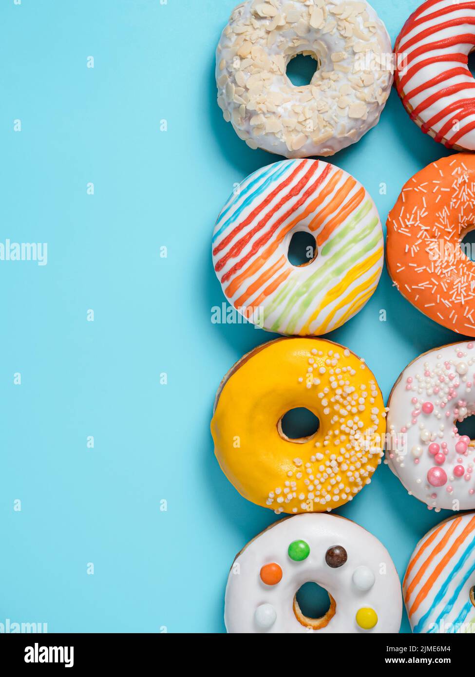 Glazed donuts on colorful background, top view Stock Photo