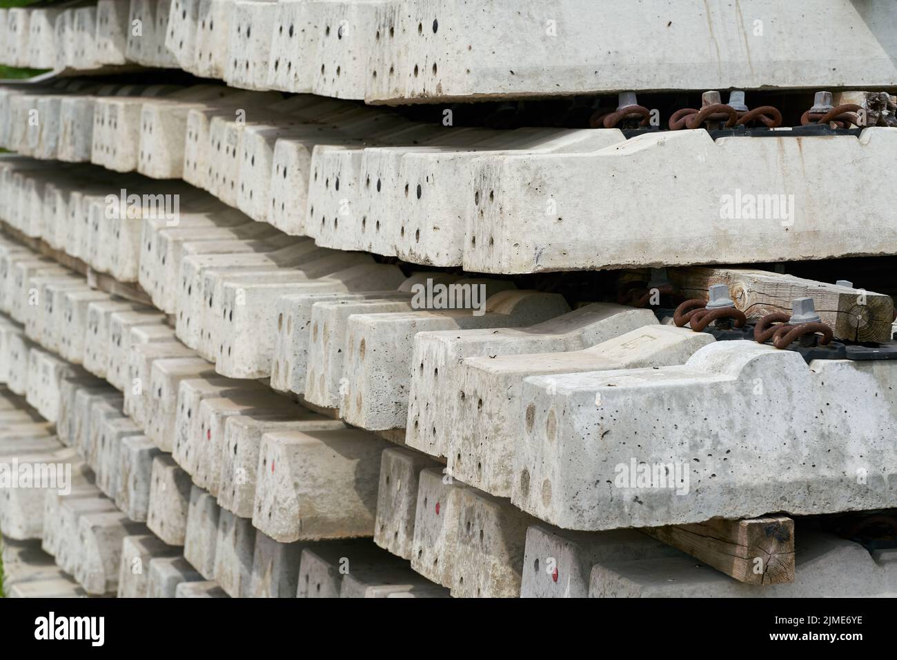 New concrete railroad sleepers at the storage yard of a construction site Stock Photo