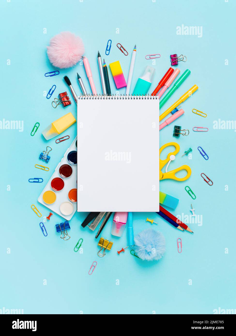 School supplies and empty notebook on blue bckg Stock Photo
