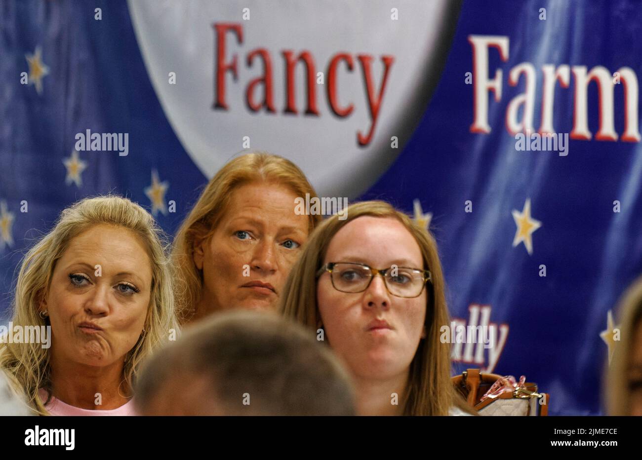 Calvert City, KY, USA. 05 Aug 2022. Two women grimace and one frowns while listening to Kelley Paul speak at the Night Before Fancy Farm West Kentucky GOP Rally at the Calvert City Civic Center. The keynote address was originally scheduled to be delivered by her husband, Sen. Rand Paul, who had to stay in Washington due to a Senate vote being scheduled for Aug. 6. (Credit: Billy Suratt/Apex MediaWire via Alamy Live News) Stock Photo