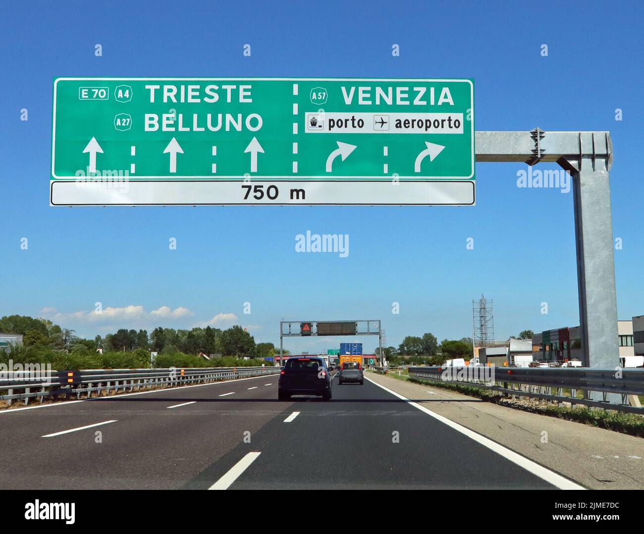 Motorway junction with large sign with directions to major cities in Italian such as Venice and the airport Stock Photo
