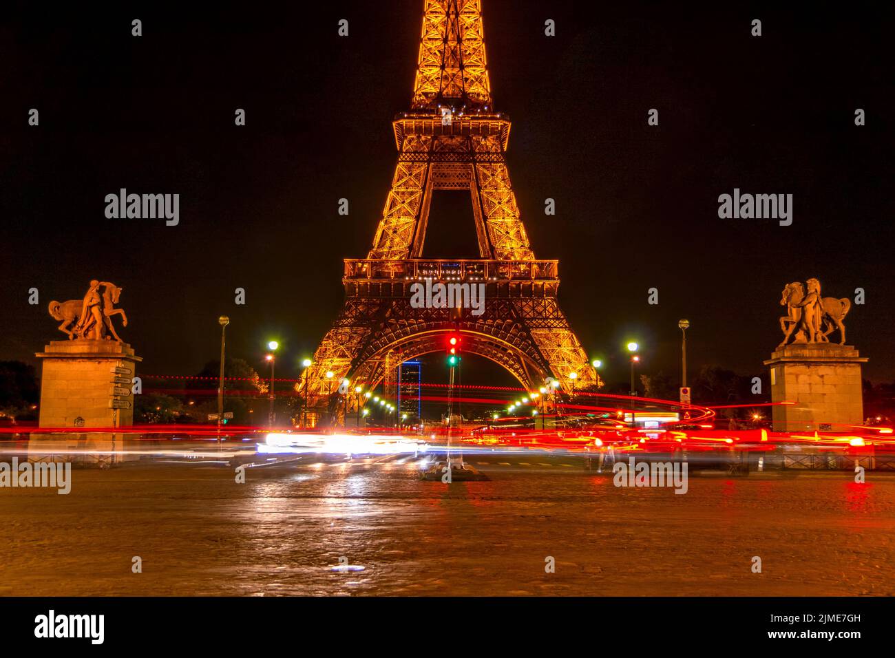 Eiffel Tower and Many Lights of Night Traffic on the Jena Bridge Stock Photo