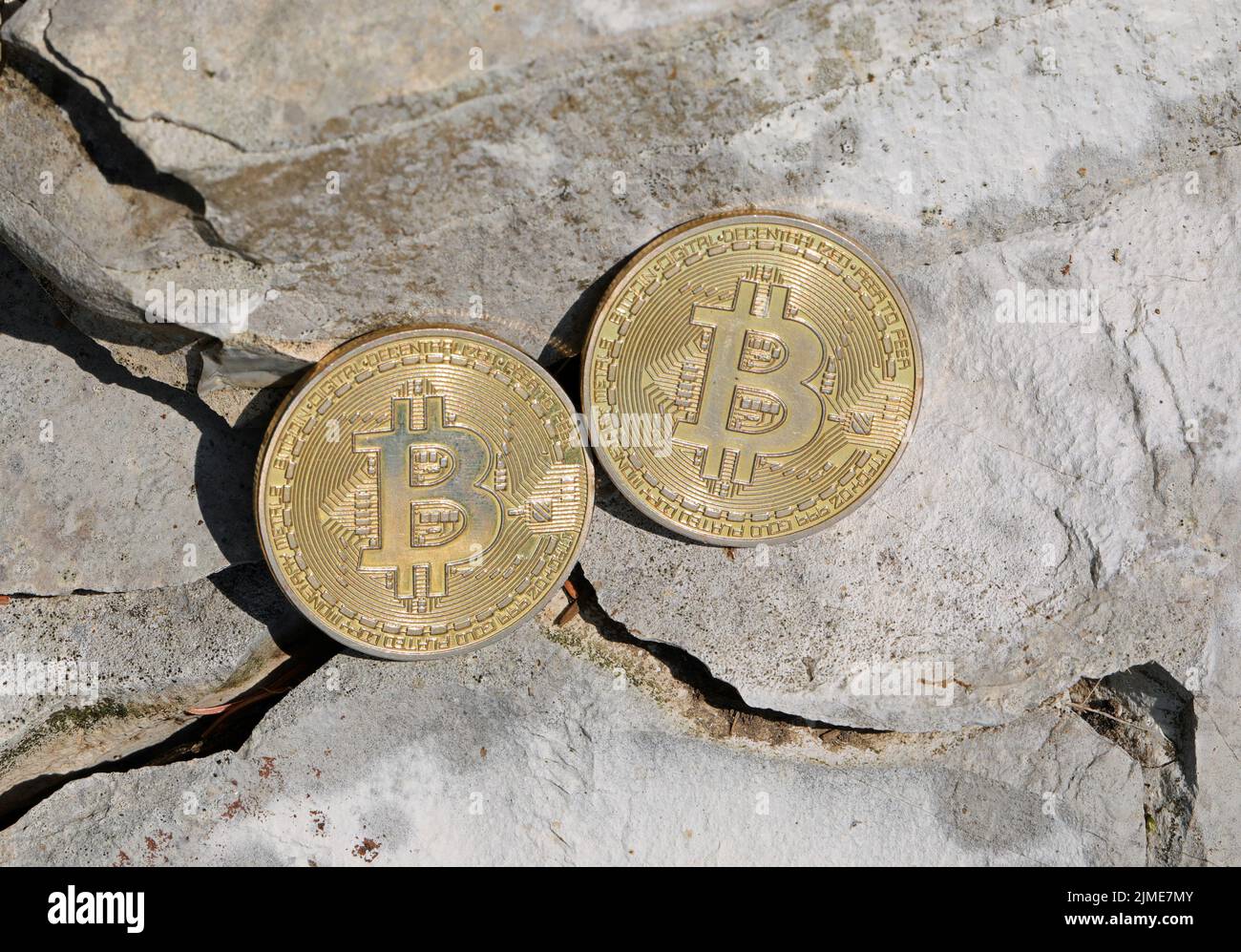 two large golden coins with the capital letter B symbolizing the cryptocurrency  BITCOIN on the stones Stock Photo - Alamy