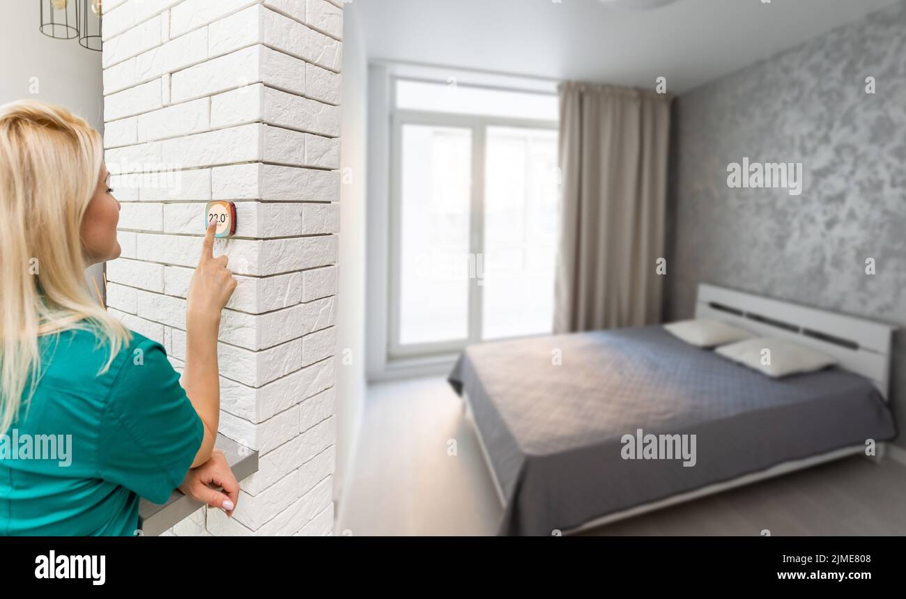 Woman controlling smart home devices using a digital tablet with ...