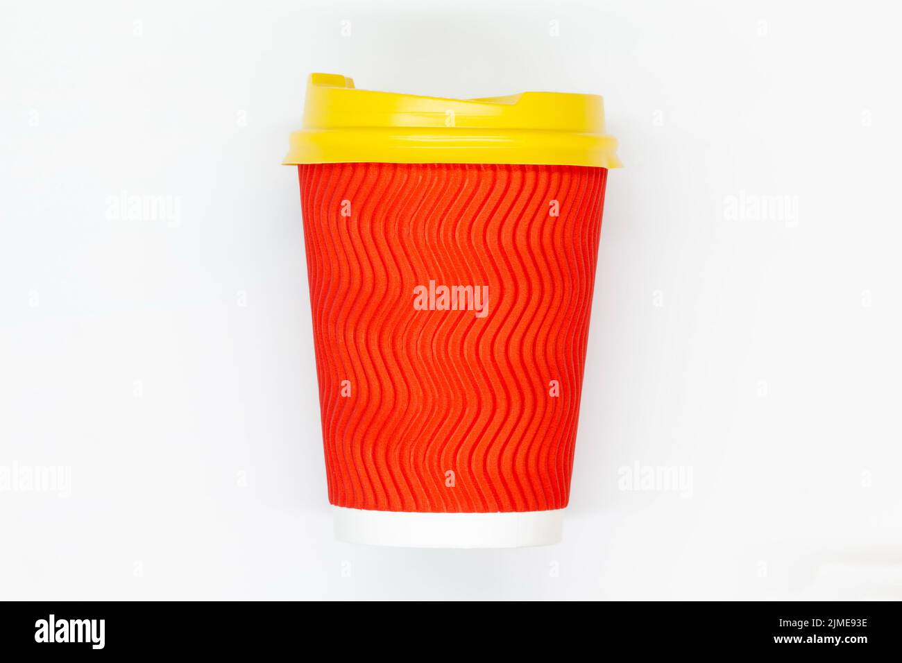 Paper coffee cup. Red craft paper coffee cup with yellow plastic lid ...