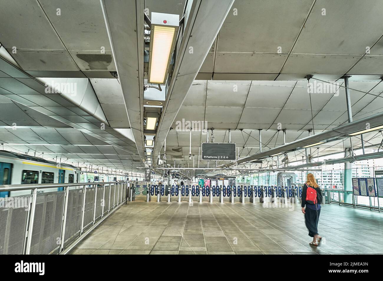 A traveler in the concourse near the ticket barrier at Blackfriars rail station, London, England. Stock Photo
