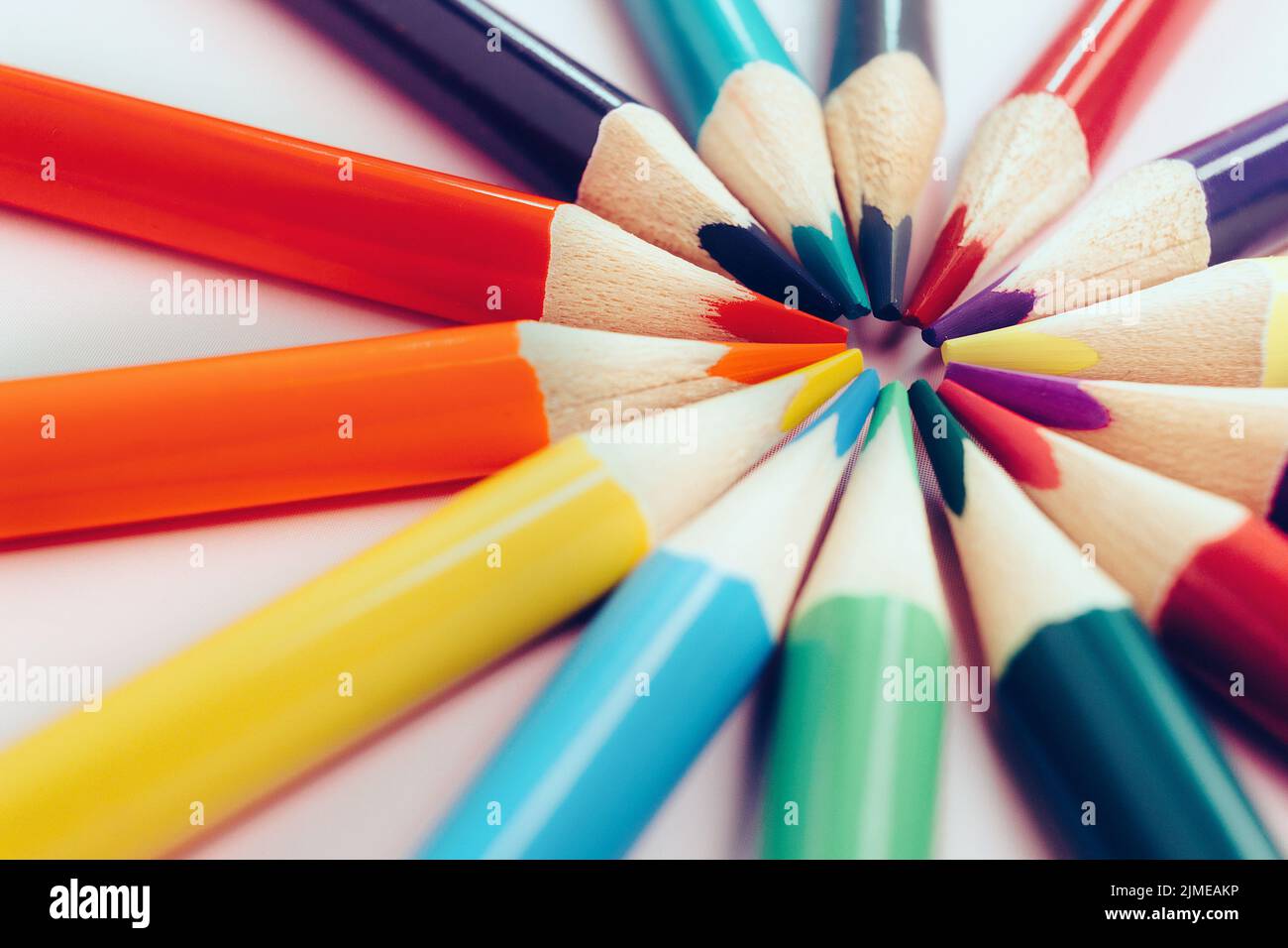 A figure of colored pencils in the shape of the sun with rays. The concept of creativity or development of the group. Stock Photo