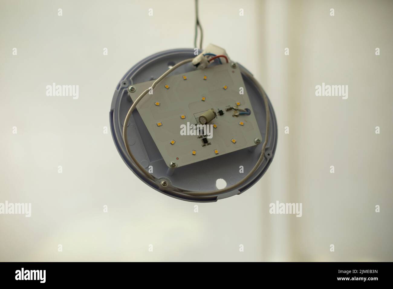 Broken light fixture. Torn wire. Round LED light is ruined. Vandalism in detail Stock Photo Alamy