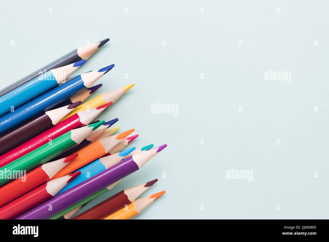 Background with colored pencils and space for copying. Top view. Stock Photo
