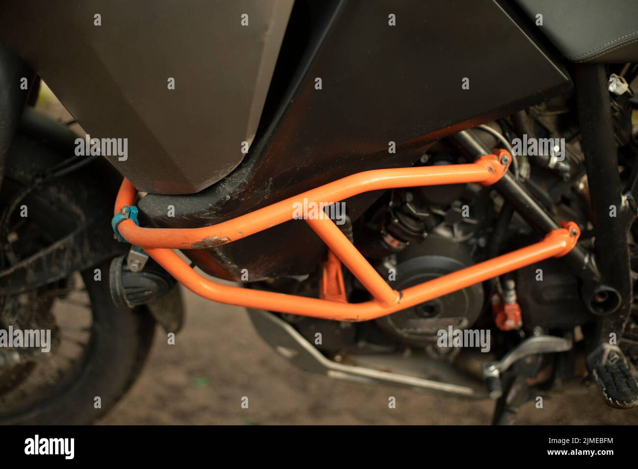 Motorcycle protection. Bike is in details. Orange steel shock blocker ...
