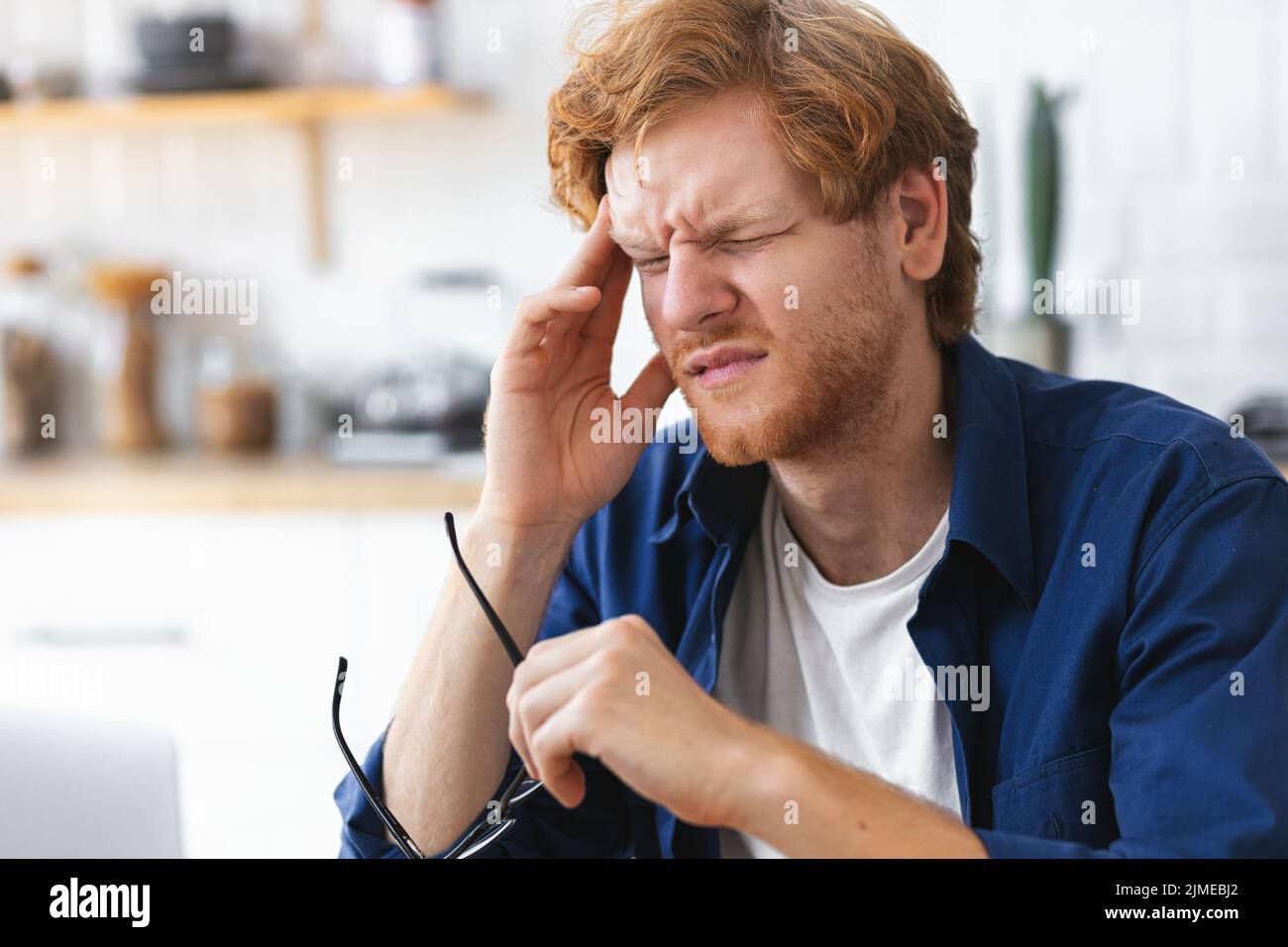 portrait of tired stressed man having headache feeling sick pain depression overwork concept Stock Photo