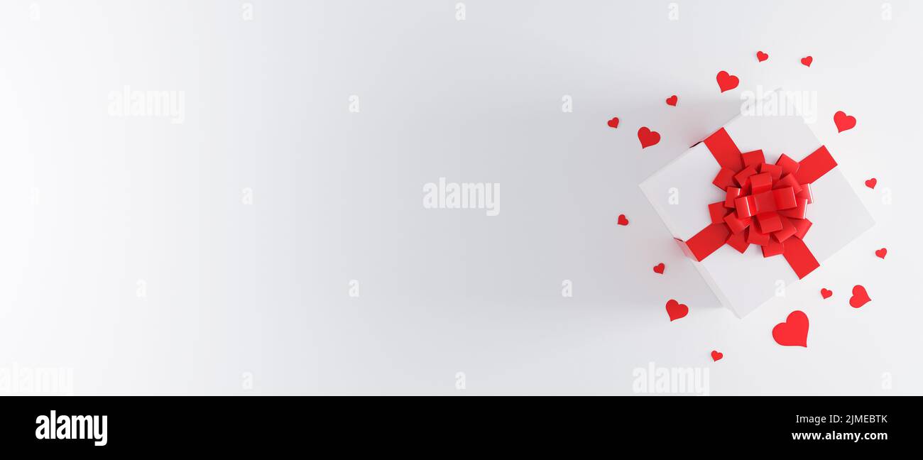 White gift box with red ribbon bow on white background with heart ...