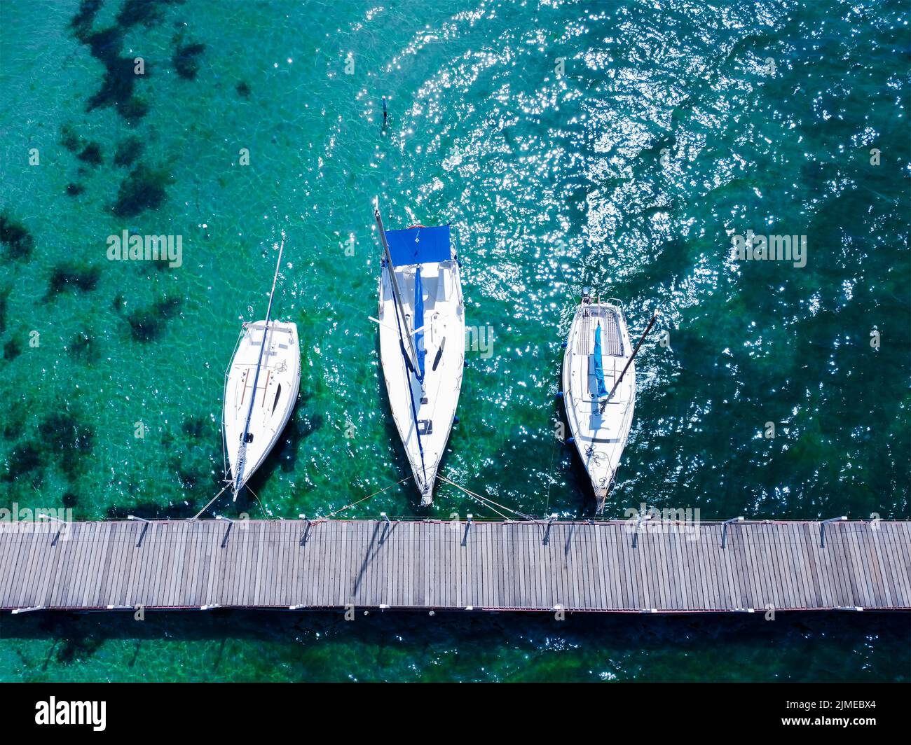 Boats at the pier in the Mediterranean Sea. Turquoise clear water. Recreation and tourism between Europe and Asia. Stock Photo