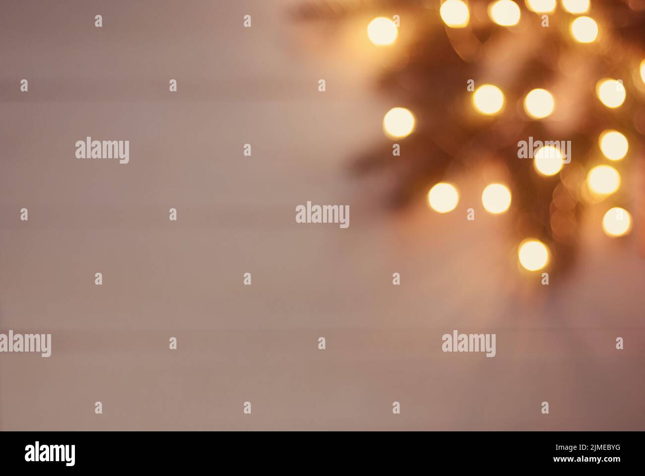 Christmas bokeh background of blurry lights and twigs in the corner Stock Photo
