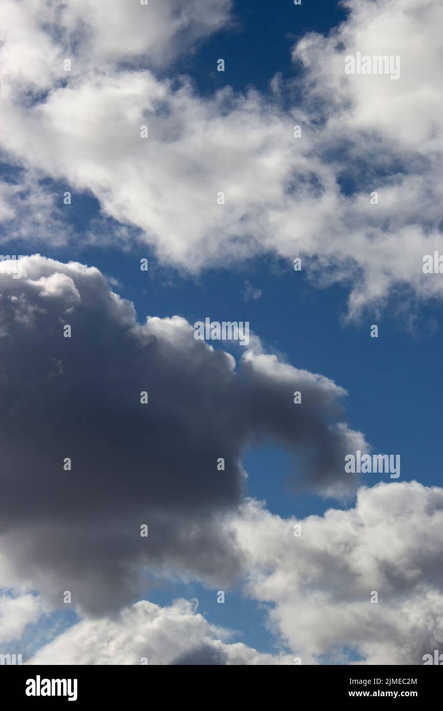 A black cloud behind which the sun hid. Horizontal picture of blue sky