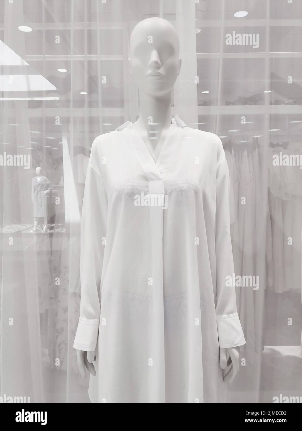 Clothing store window, mannequin in white shirt Stock Photo