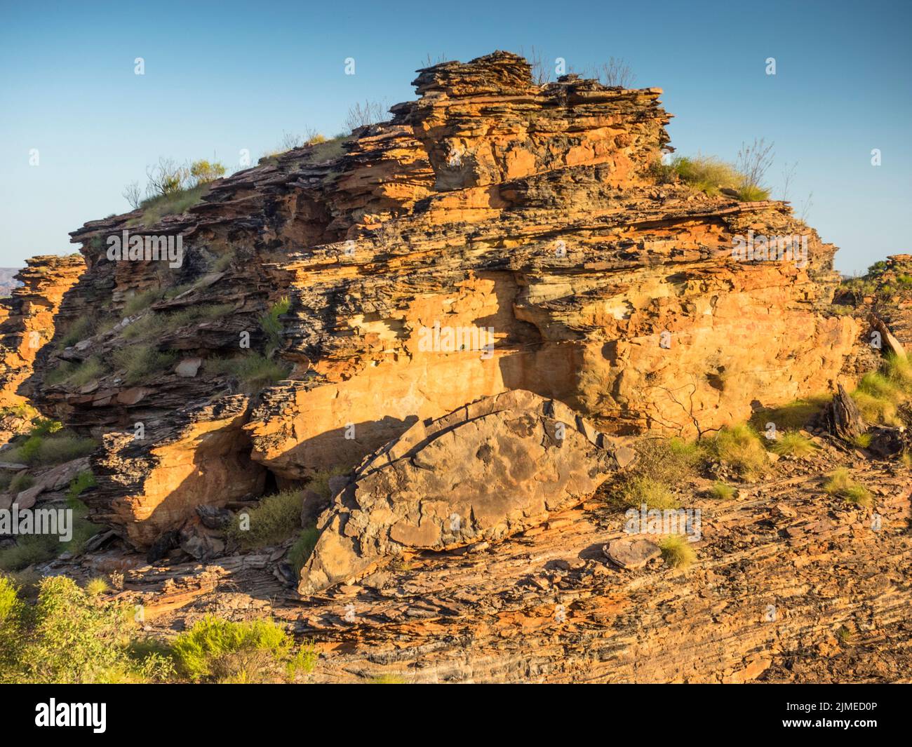 Quartz sandstone and congolmerate sedimentary karst rock formations above spinifex, Mirima National Park, East Kimberley Stock Photo