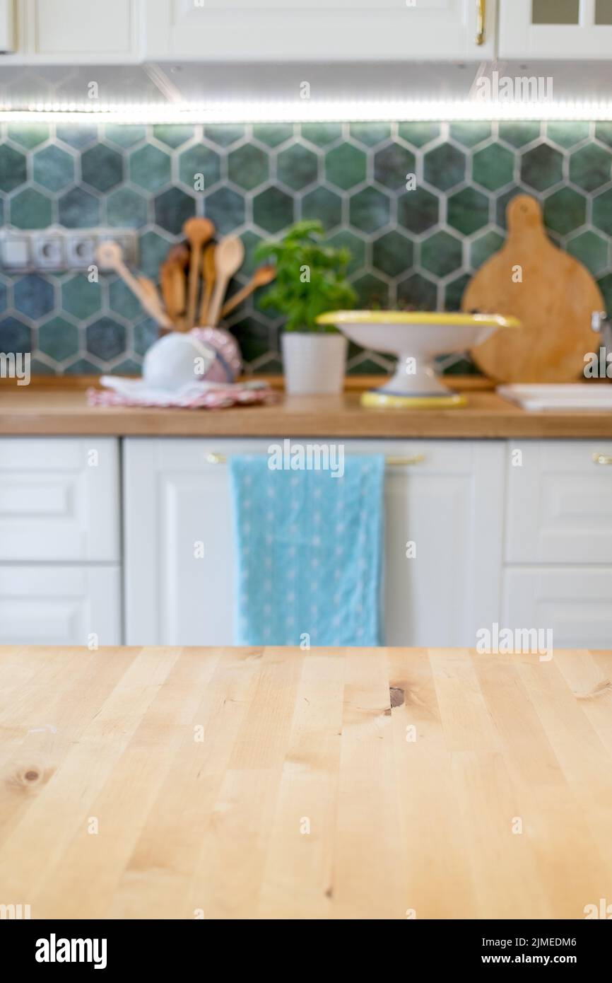 Blurred kitchen interior and wooden desk space home background Stock Photo