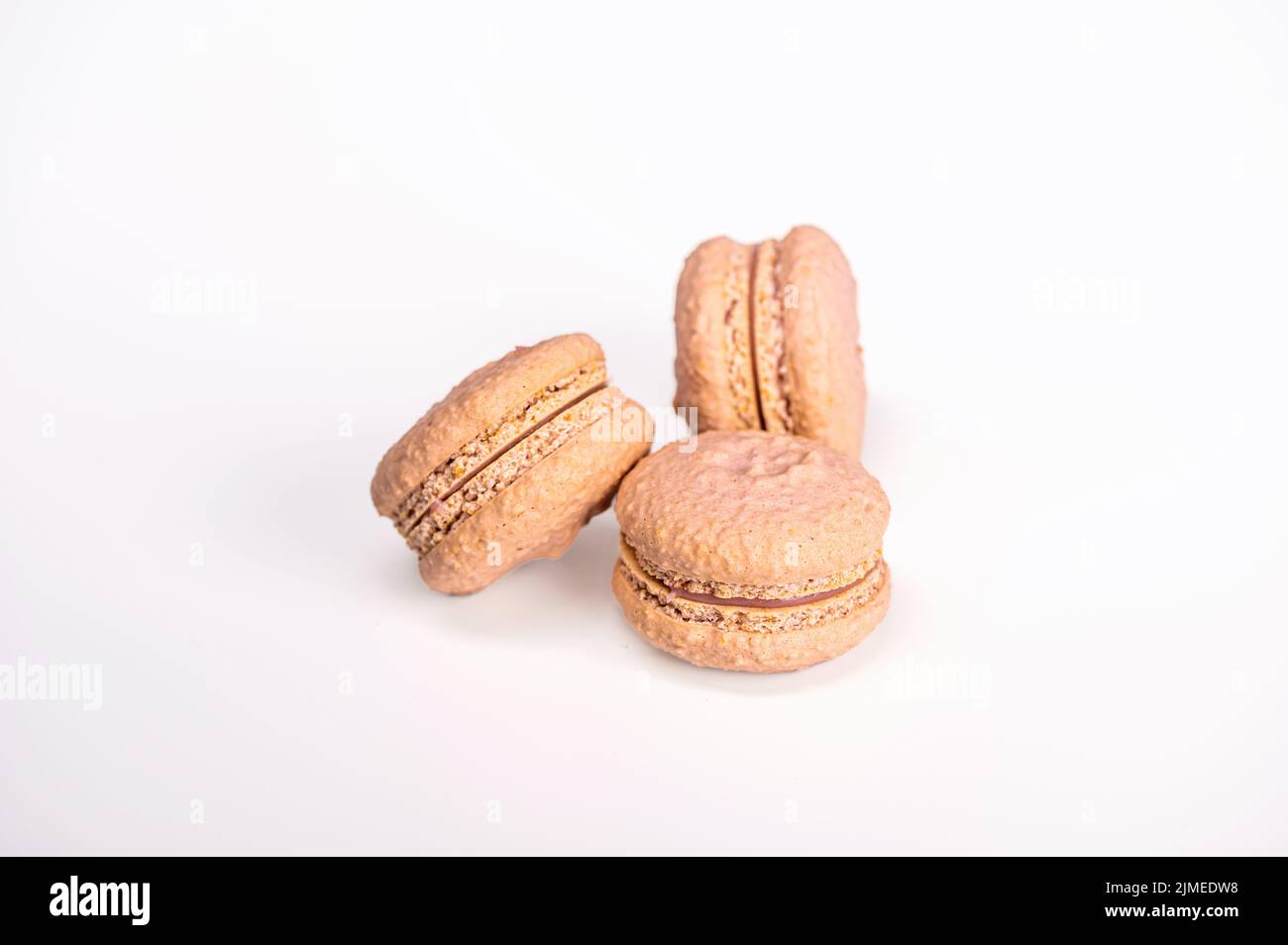 macarons, confectionery sweet product, three pink macarons isolated on white background Stock Photo