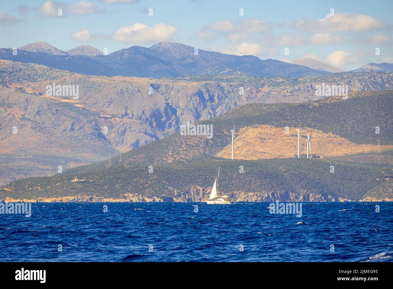 Sailing Yacht and Hilly Coast With Wind Farms Stock Photo Alamy