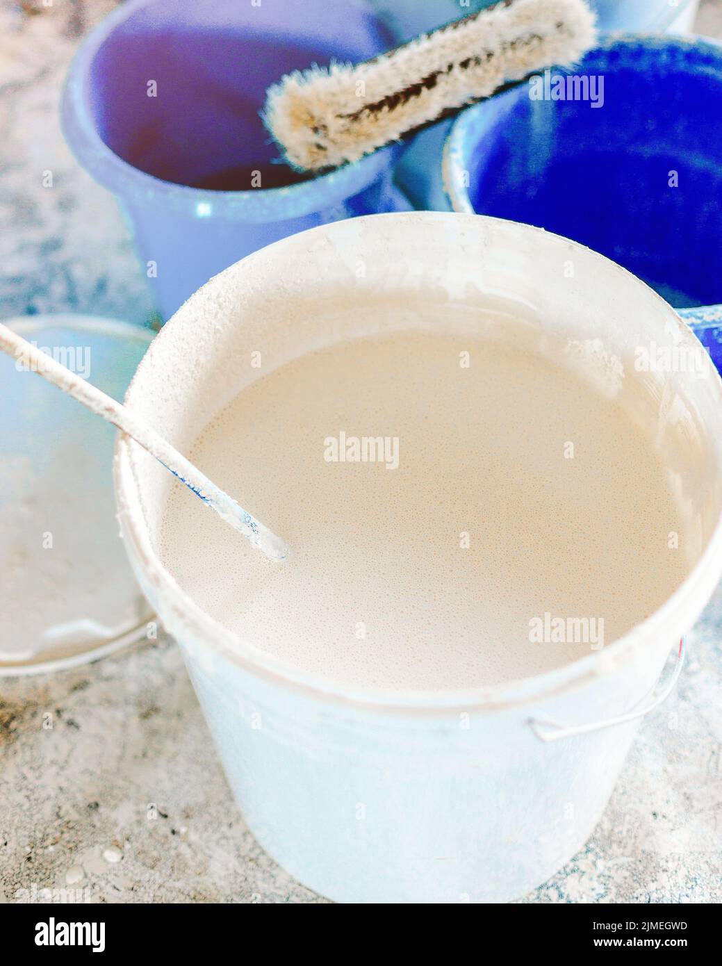 The concept of repair of the house and premises. Buckets of paint and lime for whitewashing and painting walls. Stock Photo