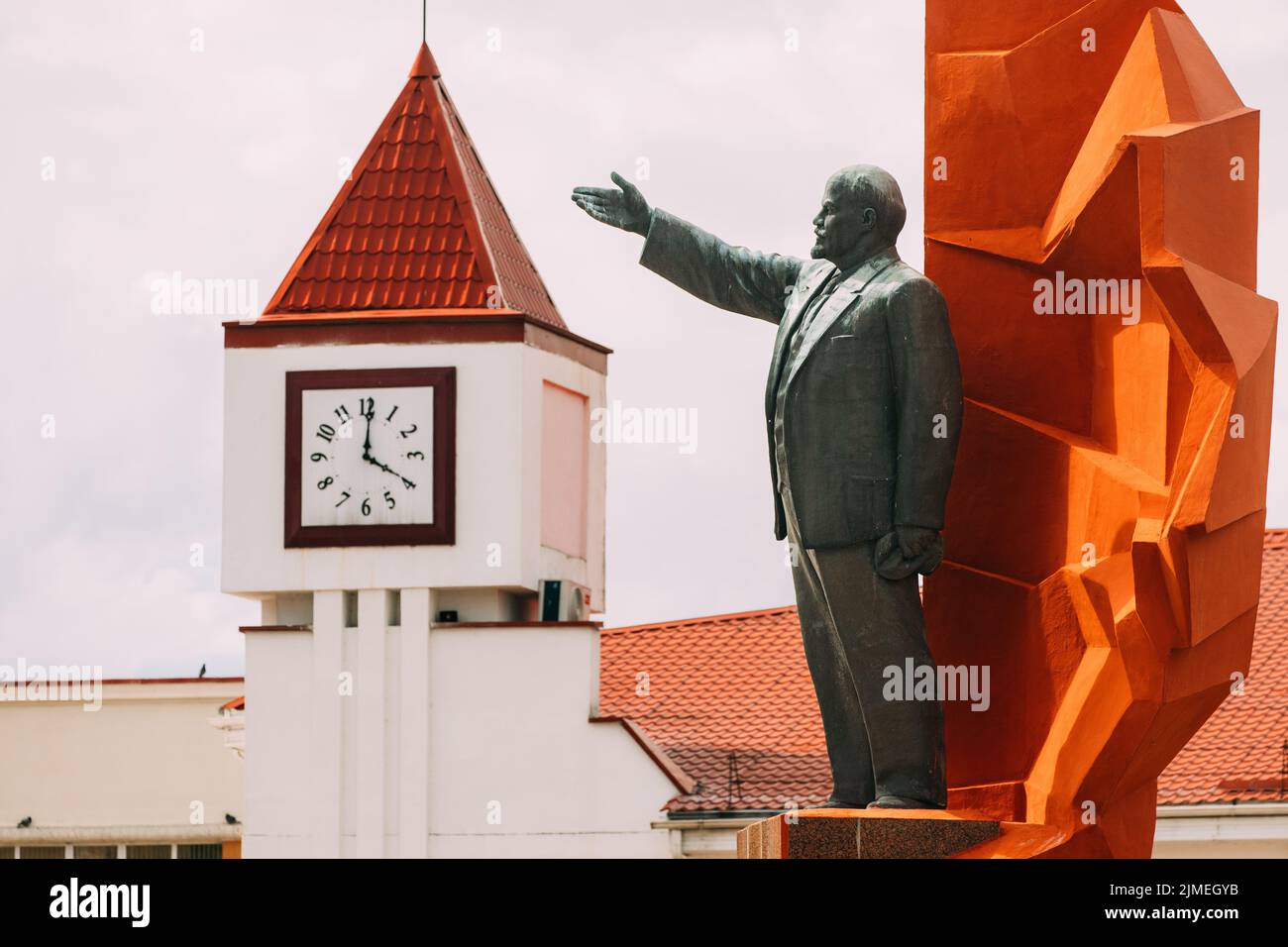 Mozyr, Belarus. Vladimir Lenin Stone Monument Infront Of City Palace Of Culture With Tower Clock. Founder Of Communism. Vladimir Lenin Was A Russian R Stock Photo