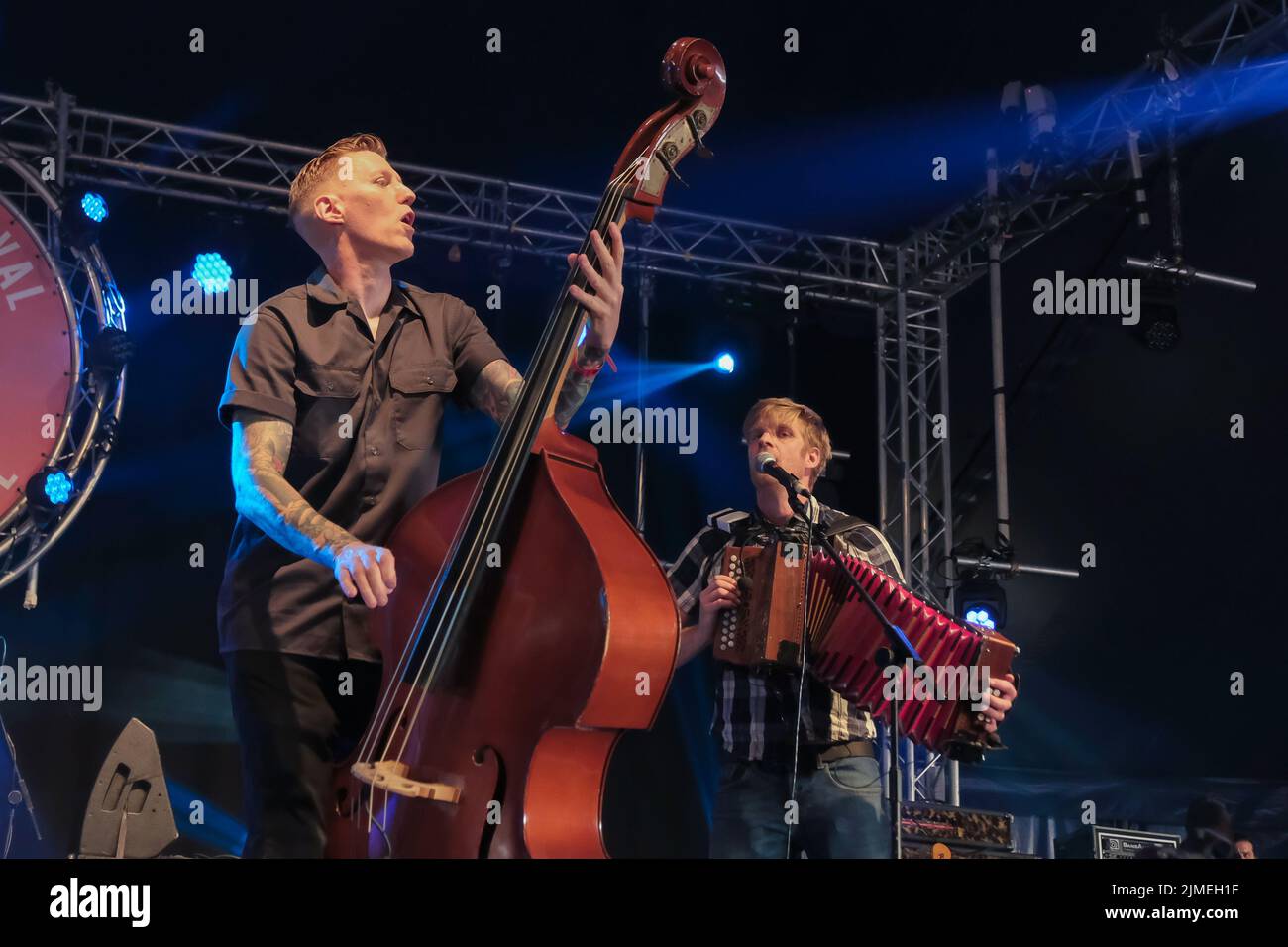 Scott Milsom, double bass, bass guitar and vocalist and Maxwell Thomas, melodion and mandolin perform live on stage with punk folk band Skinny Lister at Wickham Festival, Hampshire. Skinny Lister are a British folk band formed in London in 2009. Initially performing as a five-piece band until October 2013 when a drummer was added. They are signed to Xtra Mile Recordings, and were previously signed to Sunday Best Records in the UK, SideOneDummy Records in the US and Uncle Owen Records in Japan. (Photo by Dawn Fletcher-Park/SOPA Images/Sipa USA) Stock Photo