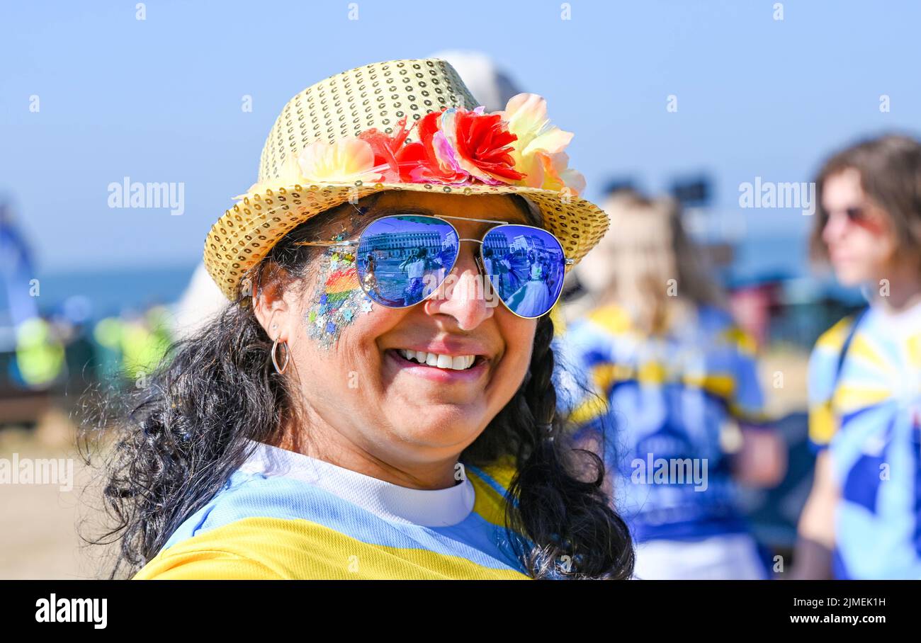 Brighton UK 6th August 2022 - Early arrivals get ready for Brighton and Hove Pride Parade on a beautiful hot sunny day. With good weather forecast large crowds are expected to attend the UK's biggest LGBTQ Pride festival in Brighton over the weekend : Credit Simon Dack / Alamy Live News Stock Photo