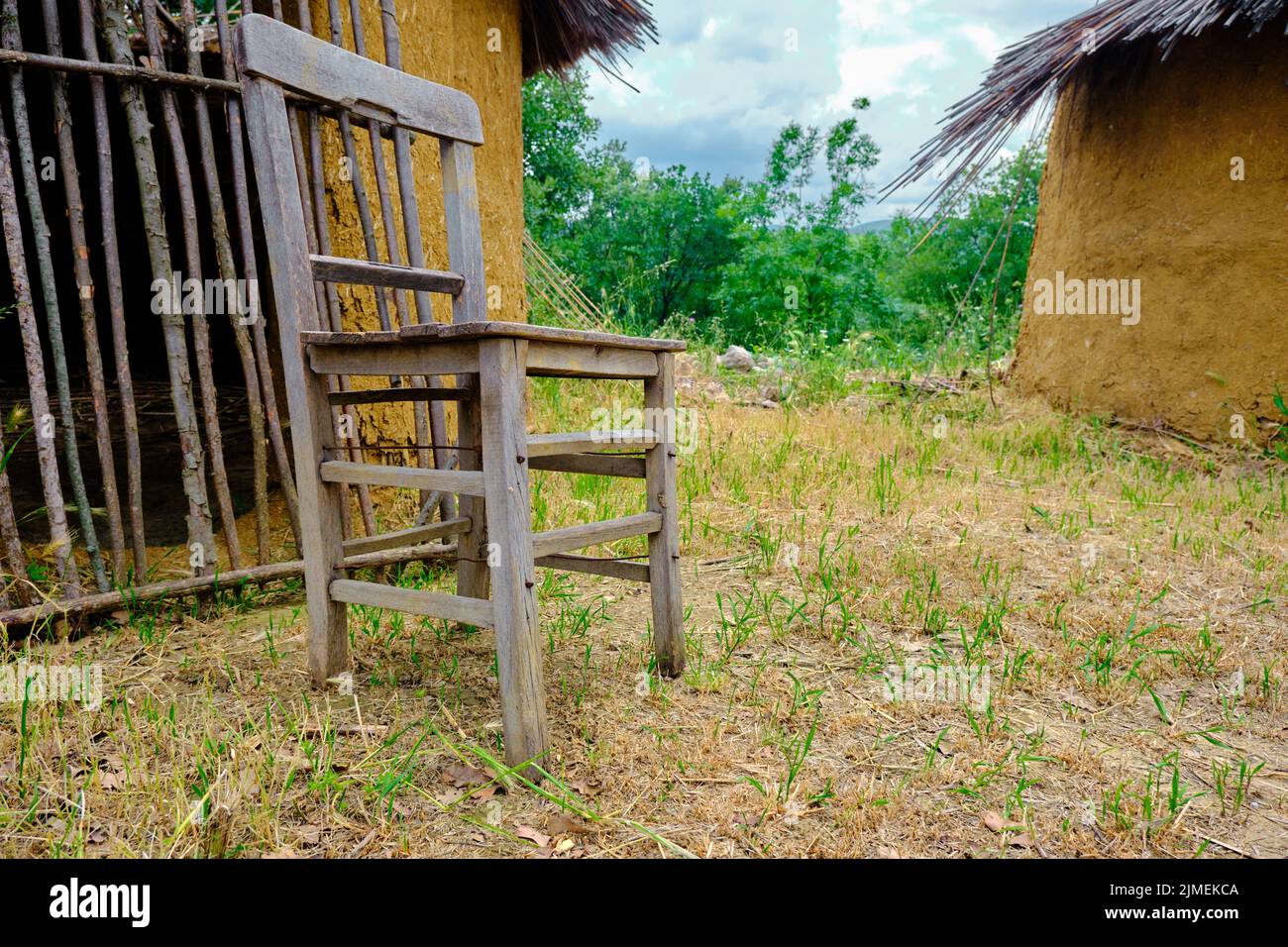 wooden made chair, retro style chair infront of the mud made bamboo house Stock Photo Alamy